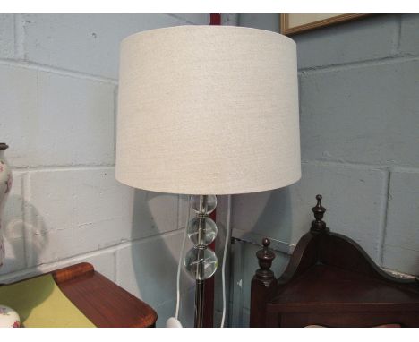 A modern standard lamp with clear ball detail 