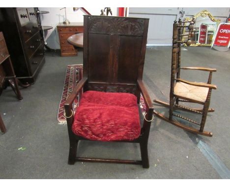 A 17th Century and later oak wainscot type tavern chair with carved panel back over brass ring dog tie end arms on outswept l