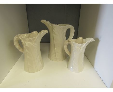 A set of three Royal Worcester leaf design graduating jugs 