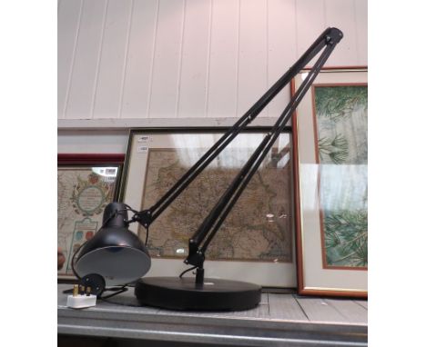 A black anglepoise style lamp 