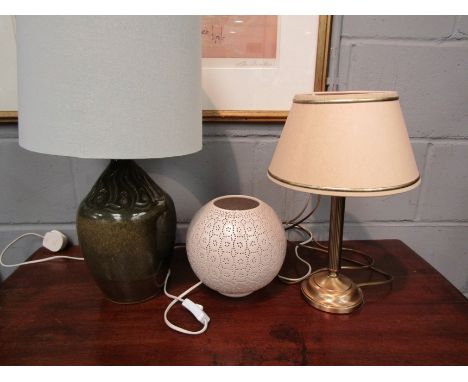 A glazed stoneware lamp base, cream shade with patterned lining, a pierced cream bulbous table lamp and another cream shaded 
