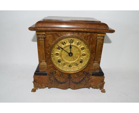 Early 20th century mantel clock in architectural type hardwood case with inlaid swag detail and a pressed metal face with Ara