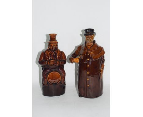 Royal Doulton Kingsware flask modelled as a coachman, and a further man on a barrel flask, both with treacle glaze, tallest 2