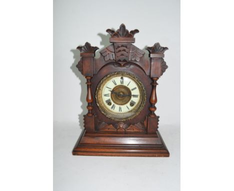 Late 19th century mantel clock by Ansona of New York, pressed metal and enamel face with Roman numerals to a brass movement s