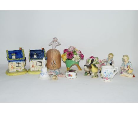 Group of English pottery and porcelain wares comprising two Staffordshire style money boxes, two ceramic bowls with flowers, 