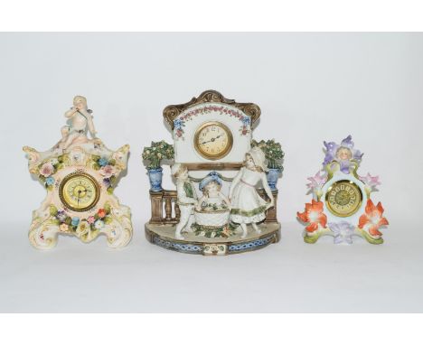 Three examples of Continental porcelain clock mantel cases, with cherubs and shaped design (3)