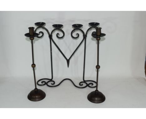 20th century iron four-light candelabra together with a pair of candlesticks (3) Condition: Good used condition