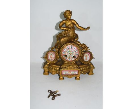 19th century Continental mantel clock in elaborate gilt metal and porcelain mounted case with figural detail, the face with R