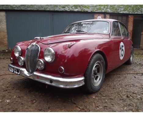 A 1963 race prepared Jaguar Mk II 3.8 litre, registration number 928 CLJ, red. This manual overdrive 3.8 Mk II was successful