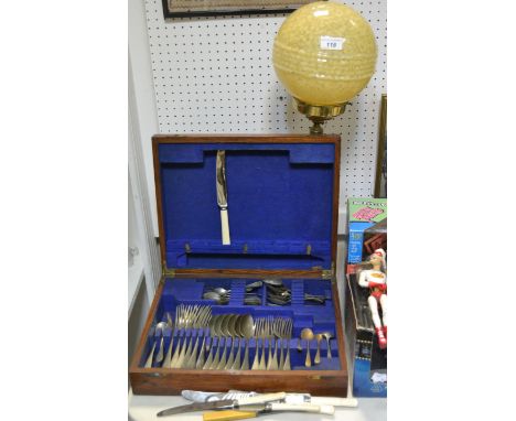 A brass oil lamp, 1930,s globular shade; an oak cutlery box and flatware 