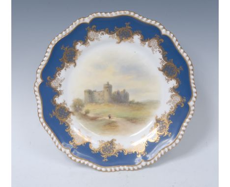 A Worcester shaped circular cabinet plate, painted by Jas Stinton, signed, with  Carew Castle, gilt border applied with gilt 