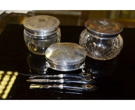 A silver jewellery box supported on three feet, Birmingham 1907; a cut glass dressing table bowl with silver and tortoiseshel