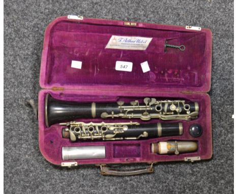 A vintage 1920s F Arthur Uebel clarinet, silver plated fittings, cased with white mouth piece