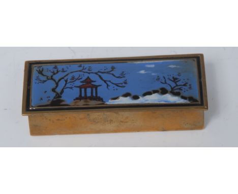 A Japanese enamel and brass rectangular stamp box, hinged cover decorated in polychrome with a pagoda in a mountain landscape