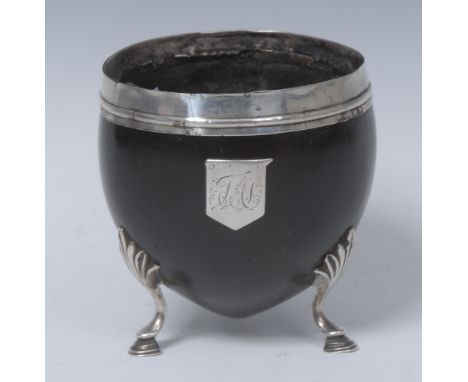 A George III Sheffield plate mounted coconut cup, deep rim with centre girdle above a shield shaped cartouche, hoof feet with