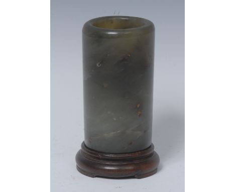 A Chinese jade cylindrical brush pot, 9.5cm high, hardwood stand   Condition Report:  Inclusion to the Jade on the outer rim 