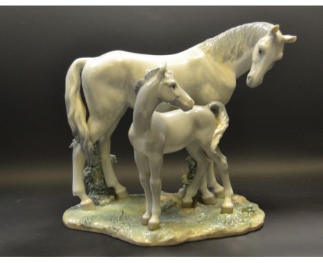 A Lladro model of a dapple Grey Mare and Foal   Condition Report:  This item is in good condition with no obvious signs of da