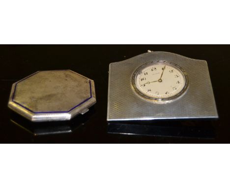 An Art Deco  silver compact with engine turned decoration and blue enamel band, London 1934; a silver 8 day clock, wooden bac