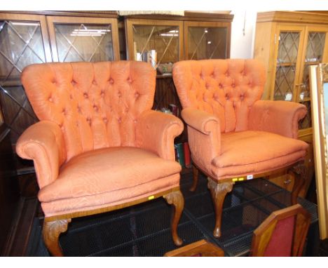 A pair of button back elbow chairs