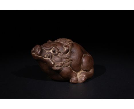**NO RESERVE**A Chinese Carved Pottery Model of a Mythical Beast, with Character Marks to the Base.A Chinese pottery figure, 