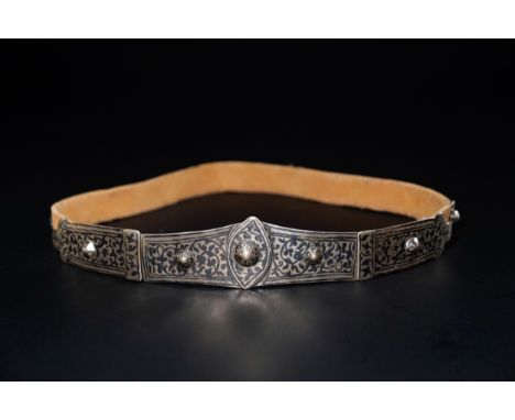 A Russian Caucasian Silver Niello Belt with Buckle.An ornate silver belt composed of interlinked panels adorned in the niello