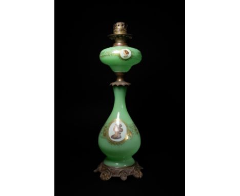 A Bohemian Green Uranium Glass Oil Lamp with Portrait Medallions. A Bohemian uranium glass oil lamp featuring an opaline gree