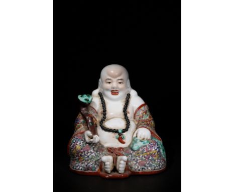 A Chinese Famille Rose Porcelain Laughing Buddha Figure.A Chinese porcelain figure of the Laughing Buddha, seated in a joyous