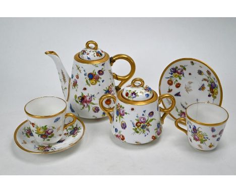 A china coffee set for two, painted with flowers and insects, inscribed in red script beneath 'Worcester', comprising coffee 