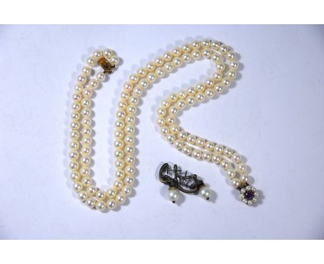 A double row of uniform cultured pearls threaded onto a 9ct rose gold clasp with pearl and amethyst cluster, approx 42 cm lon