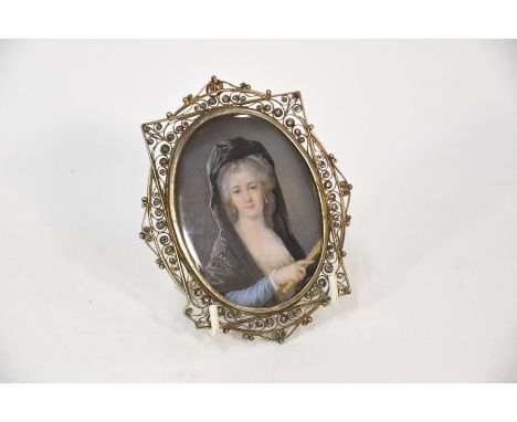 Heinrich Friedrich Füger (1751-1818) - a portrait miniature on ivory of a lady with powdered hair under a black shawl, holdin