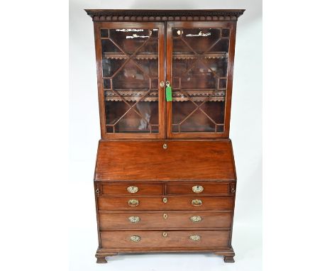 A George III mahogany astragal glazed library bureau bookcase, with fitted interior over two over three long graduated drawer