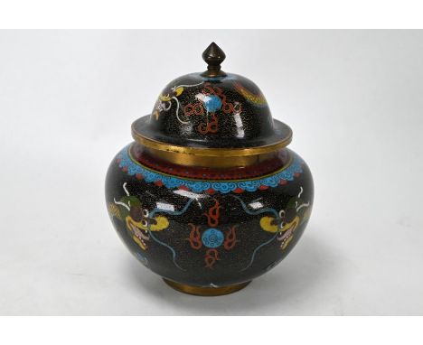 An early 20th century Chinese cloisonne jar and domed cover with knop finial, decorated in polychrome enamels with yellow dra