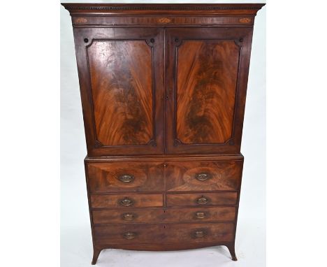 A Regency figured mahogany secretaire linen press, with slides and fitted drawer over two short and two long graduated doors 