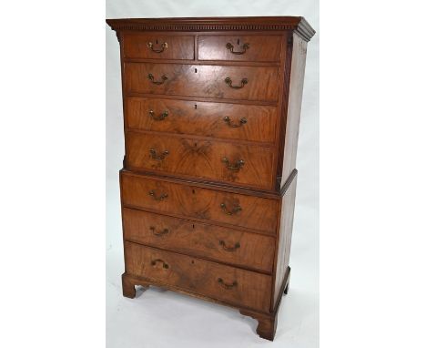 A George III mahogany chest on chest with an arrangement of two short over long graduated drawers, on shaped bracket feet, 11