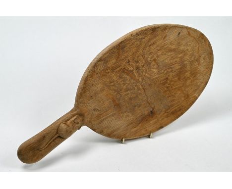 A Thompson of Kilburn 'Mouseman' oak cheeseboard of paddle form with carved mouse to handle, 37 cm long overallScrubbed condi