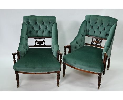 A pair of late Victorian inlaid rosewood framed part button upholstered salon armchairs, raised on turned front legs to casto