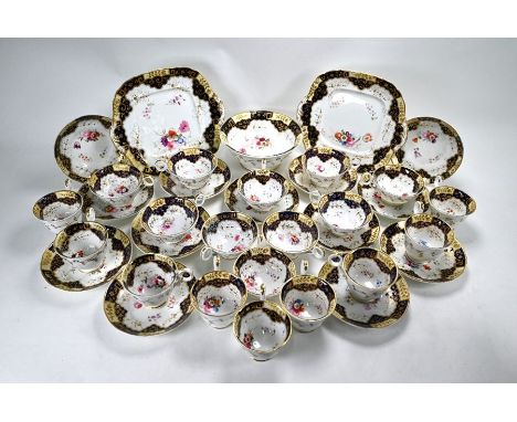A Victorian china part tea service painted with sprays of flowers within cream, blue and gilt border, comprising ten tea cups
