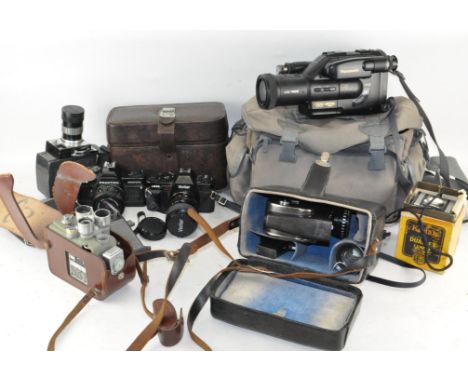 A collection of vintage cameras. including video cameras, a Praktica BCS electronic, a Panasonic G101 VHS movie camera and ot