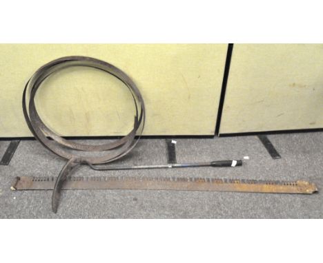 A manual two person saw, a scythe, three cooper hoops and other items