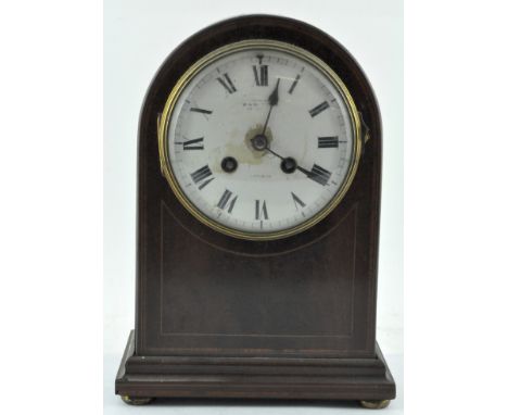 An early 20th century French mahogany mantel clock, the enamel dial with Roman Numerals denoting hours, retailed by W.A.Watki