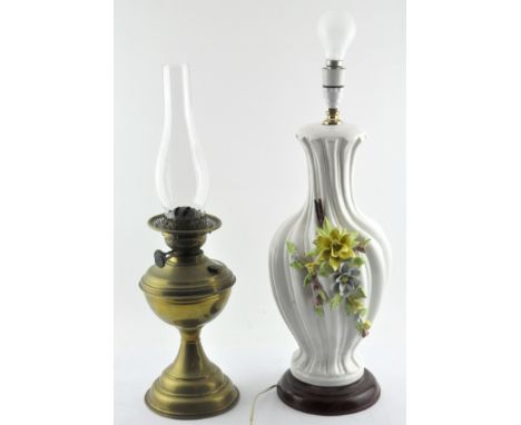 A 20th century brass oil lamp by Duplex, with glass funnel, together with a large cream-glazed ceramic spirally-moulded flowe