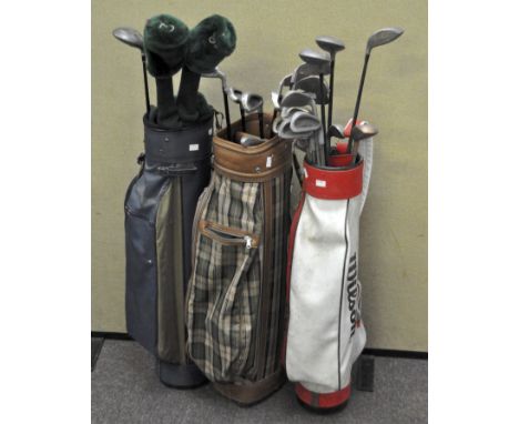 Three vintage golf bags containing a selection of vintage golf clubs, mostly by Cougar 