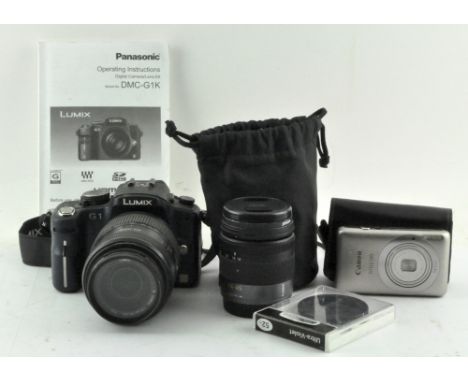 A Panasonic Lumix G1 Camera body with 45-200mm lens, together with a 14-45mm lens and a Canon Ixus 130 14.1 megapixel compact