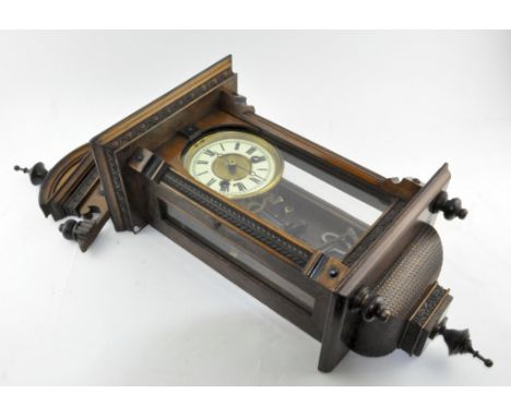 An early 20th century wall clock, the gilt and enamel dial with Roman numerals denoting hours, the case of architectural form