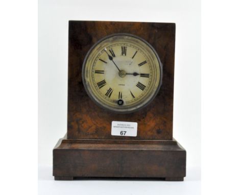 A late 19th/early 20th century walnut cased mantel clock with label to inside of door for "Camerer, Kuss &amp; Co", the dial 