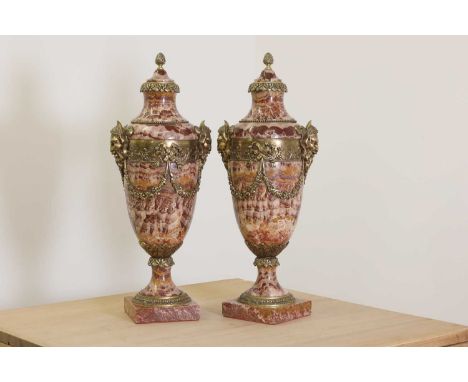 A pair of ormolu-mounted brèche rouge marble garniture urns, 1930s, of baluster form, with banded ormolu mounts, each with a 