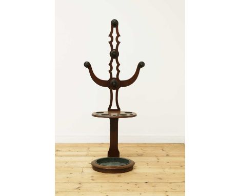 A mahogany hall stand,19th century, the pierced and carved upper section set with five hooks, over the oval stick stand below