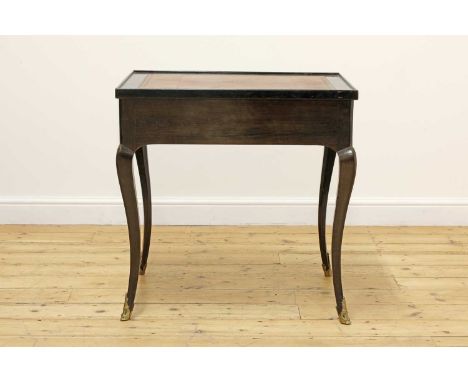 An ebony tric-trac table, 19th century, French, the turn-over top with tooled leather skiver, reversing to show an inlaid che