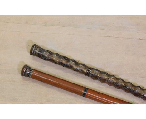 A briarwood walking stick,the base metal cap unscrewing to reveal a stemmed cup, the stick enclosing a long flask and stopper