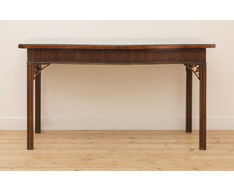 A George III strung and crossbanded mahogany serving table,the serpentine top over a fluted frieze, moulded square legs and p